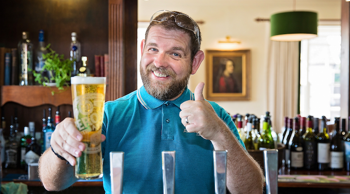 beer ready man in pub giving thumbs up with a pint